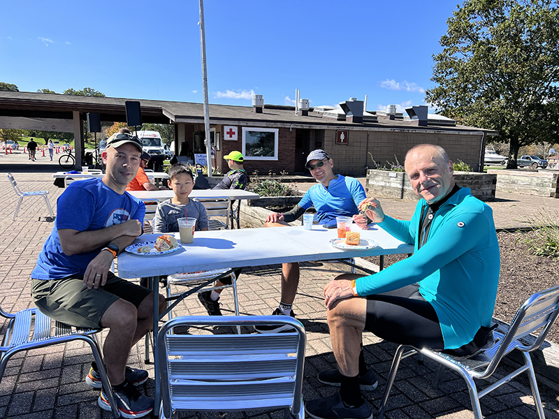 Several Lake Loop participants sit around a picnic table.