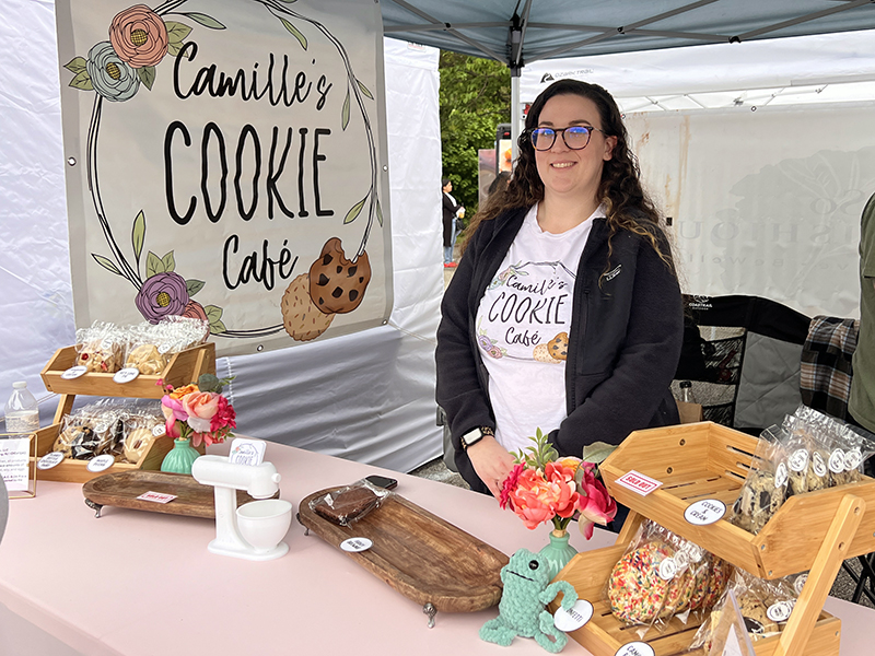 A food vendor poses at her stand.