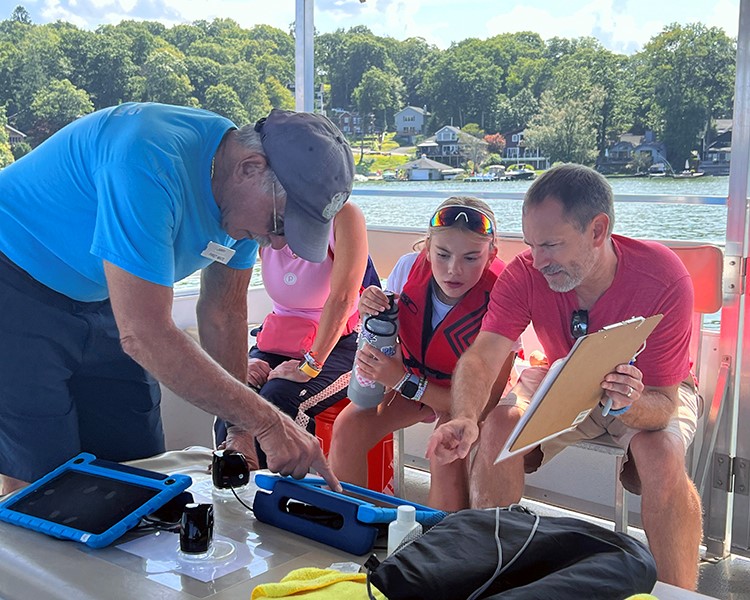 Several people engage in an experiment on the Floating Classroom